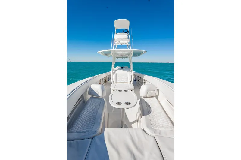 Slide: The Image of 2019 Jupiter 38 HFS boat with sleek design on open water, clear blue sky. - 84