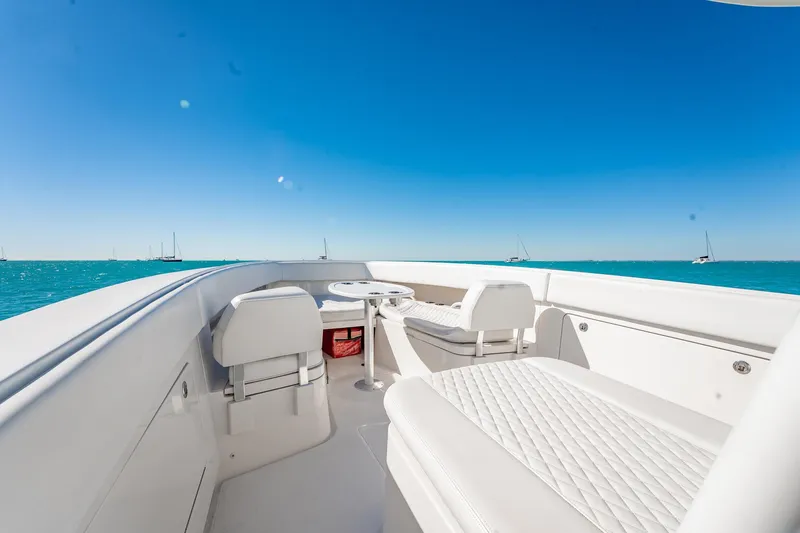 Slide: The Image of 2019 Jupiter 38 HFS boat interior with white seating, ocean view, and clear blue sky. - 86