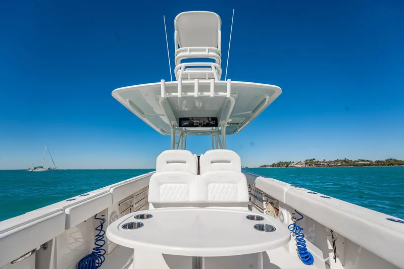Slide: The Image of 2019 Jupiter 38 HFS boat on clear blue water under a bright sky. - 92