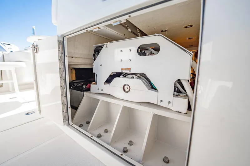Slide: The Image of 2019 Jupiter 38 HFS boat storage compartment with mechanical components visible. - 97