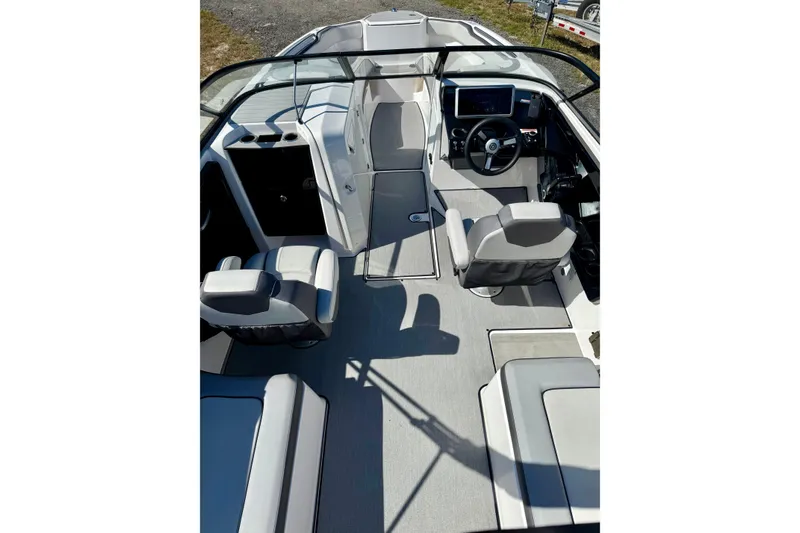 Slide: The Image of 2024 Yamaha SX 250 boat interior with modern seating and steering console. - 10