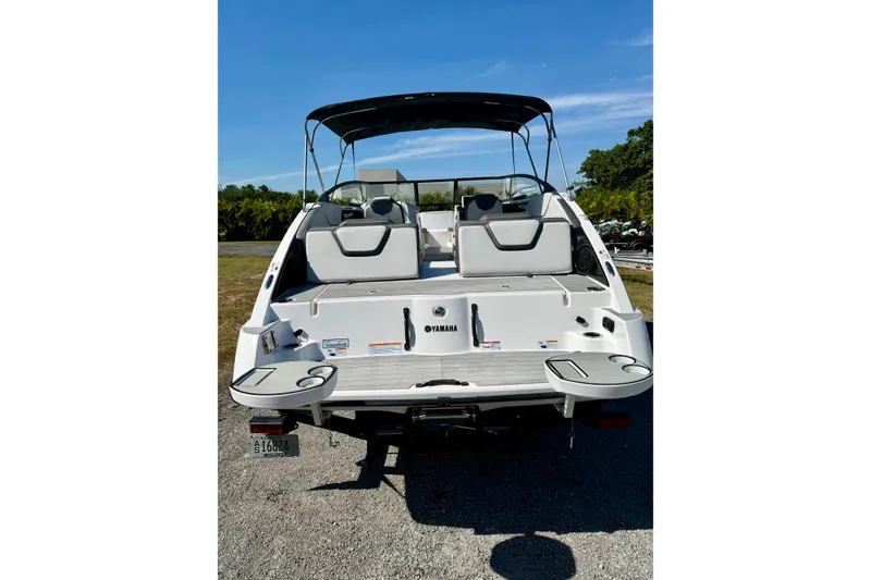 Slide: The Image of 2024 Yamaha SX 250 boat, rear view, showcasing seating and swim platform. - 27