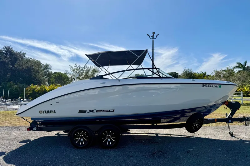 Slide: The Image of 2024 Yamaha SX 250 boat on trailer, parked outdoors under clear blue sky. - 3