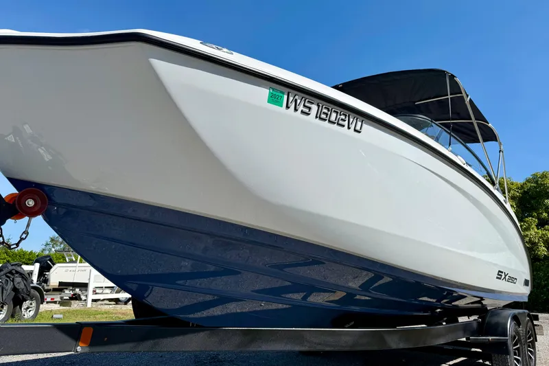 Slide: The Image of 2024 Yamaha SX 250 boat on trailer under clear blue sky. - 4
