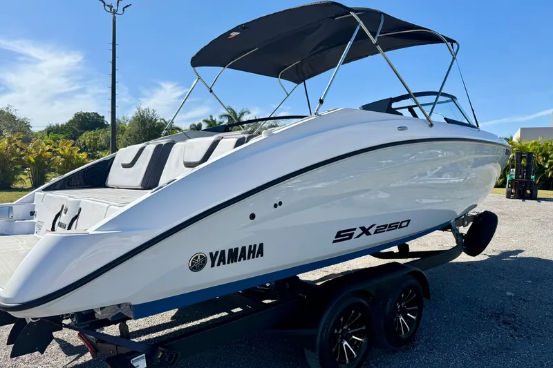 Slide: The Image of 2024 Yamaha SX 250 boat on trailer, sleek design, sunny outdoor setting. - 5