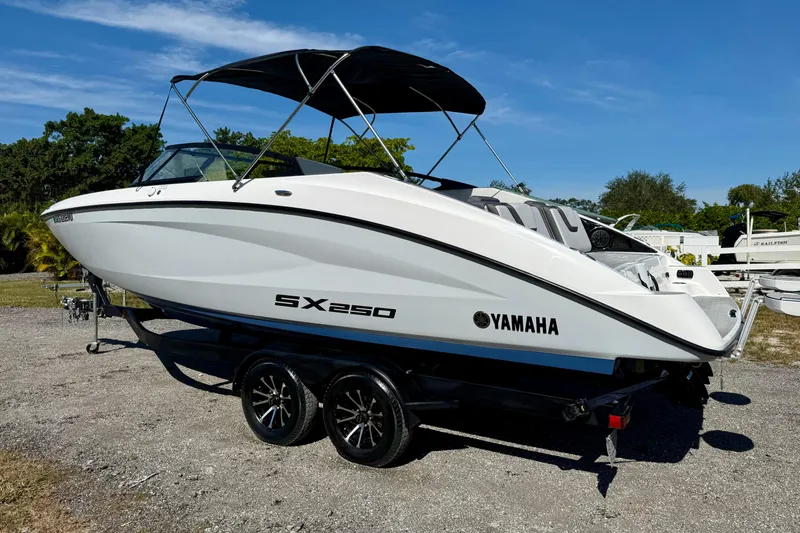Slide: The Image of 2024 Yamaha SX 250 boat on trailer, sleek design, sunny day background. - 6