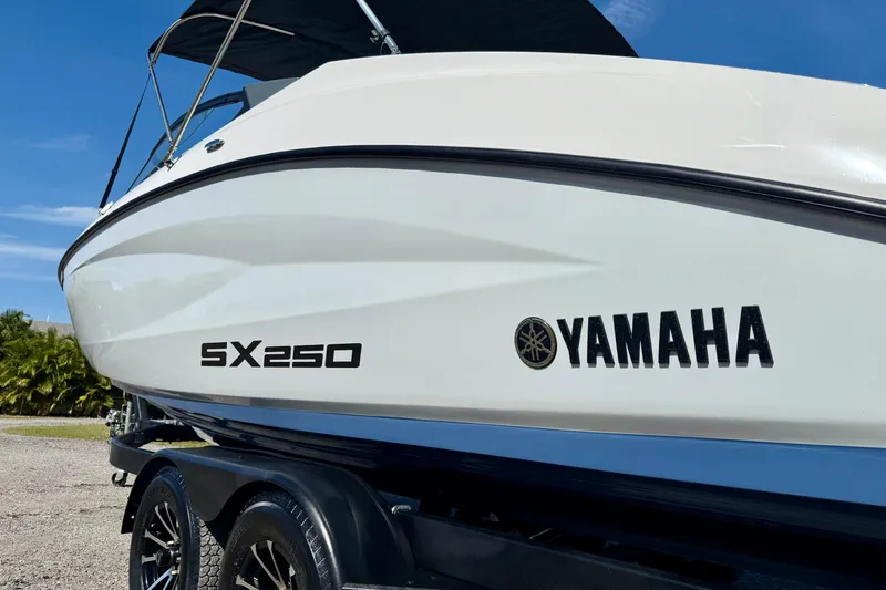 Slide: The Image of 2024 Yamaha SX 250 boat on trailer, showcasing sleek design and branding. - 8