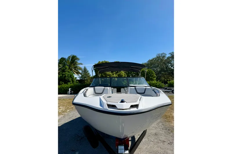 Slide: The Image of 2024 Yamaha SX 250 boat on trailer, sunny day, lush greenery background. - 9