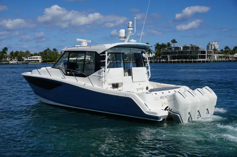 Slide: The Image of 2021 Boston Whaler 405 Conquest cruising on a sunny day with clear blue skies. - 13
