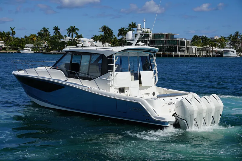Slide: The Image of 2021 Boston Whaler 405 Conquest boat cruising on a sunny day, surrounded by palm trees. - 14