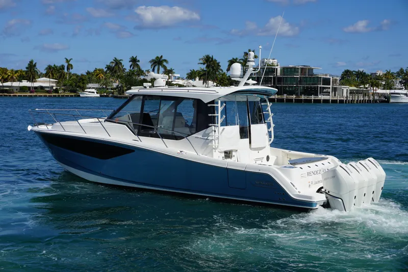 Slide: The Image of 2021 Boston Whaler 405 Conquest cruising on a sunny day near luxury waterfront homes. - 15