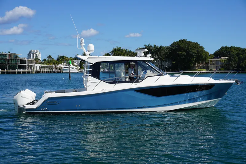 Slide: The Image of 2021 Boston Whaler 405 Conquest boat cruising on a sunny day. - 2