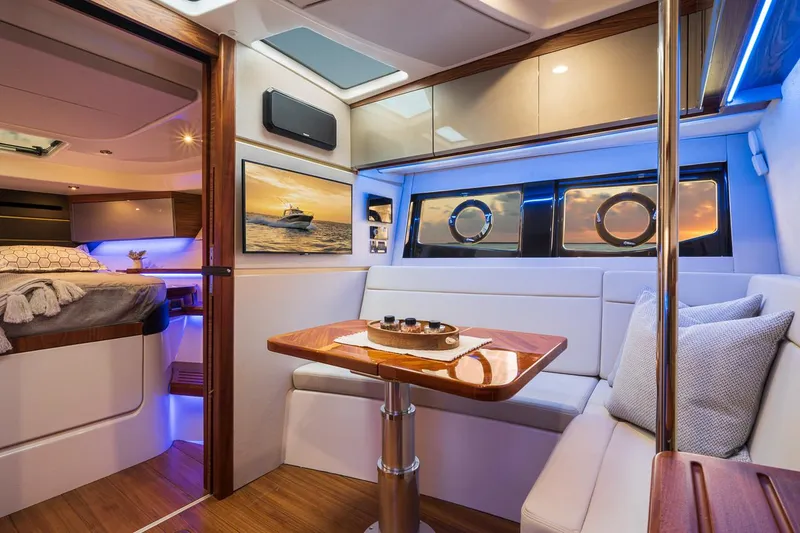 Slide: The Image of Manufacturer Provided Image: Luxurious interior of 2021 Boston Whaler 405 Conquest yacht with dining area and bedroom. - 29