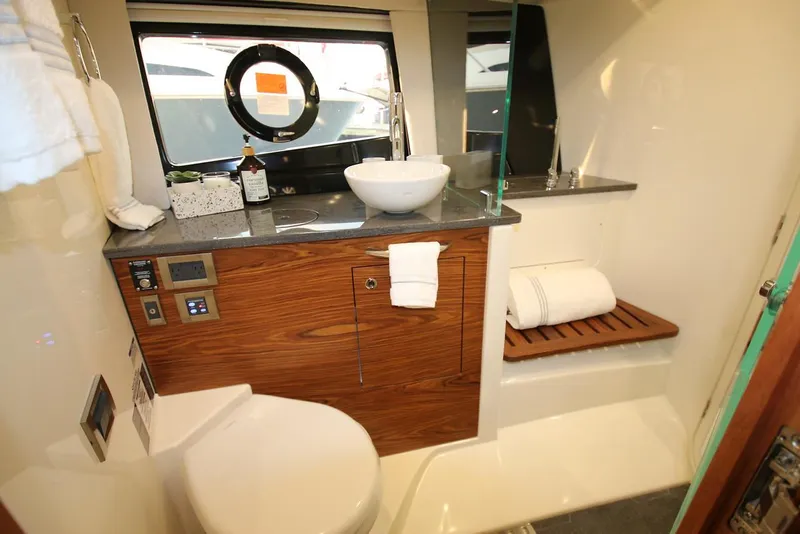 Slide: The Image of Manufacturer Provided Image: Modern bathroom interior of 2021 Boston Whaler 405 Conquest boat with wooden cabinetry. - 37