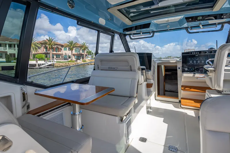 Slide: The Image of Interior of 2021 Boston Whaler 405 Conquest yacht with luxurious seating and scenic waterfront view. - 38