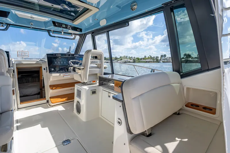 Slide: The Image of Interior of 2021 Boston Whaler 405 Conquest boat with helm and seating area. - 39