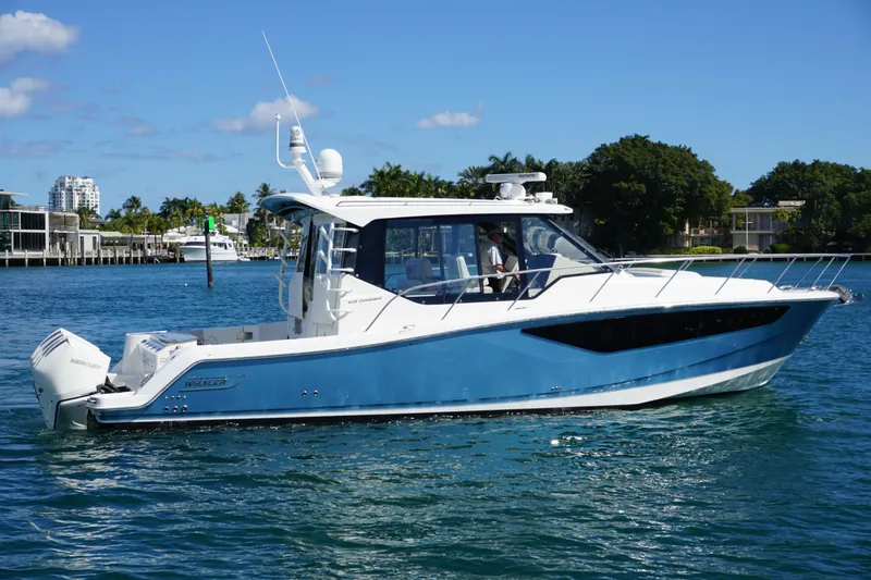 Slide: The Image of 2021 Boston Whaler 405 Conquest boat cruising on clear blue water. - 4