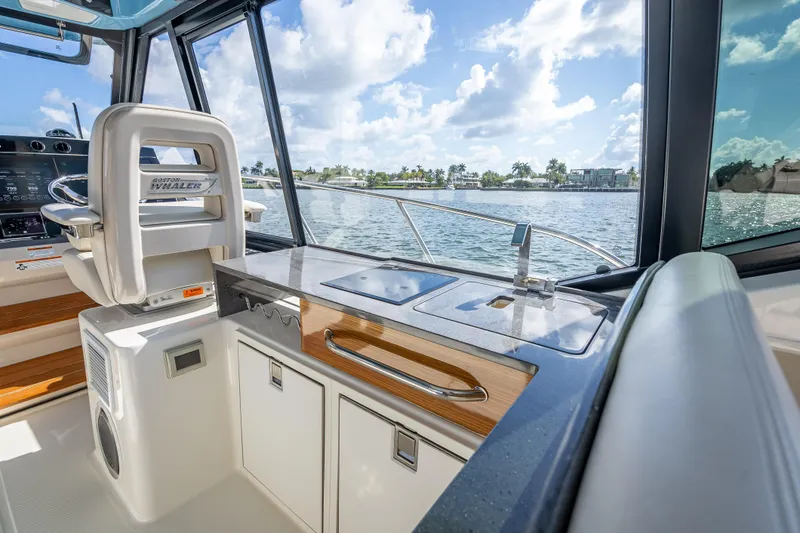 Slide: The Image of Interior view of 2021 Boston Whaler 405 Conquest yacht with helm and kitchenette. - 40