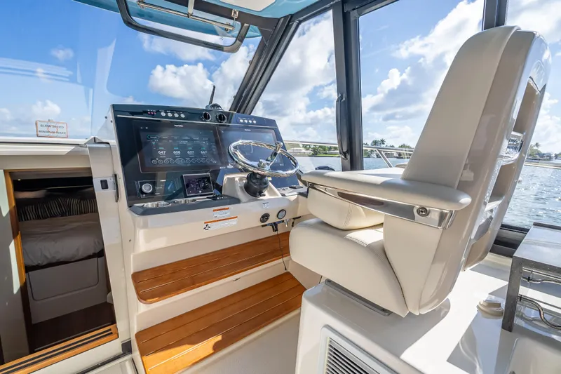 Slide: The Image of Helm of 2021 Boston Whaler 405 Conquest with modern controls and luxurious seating. - 41