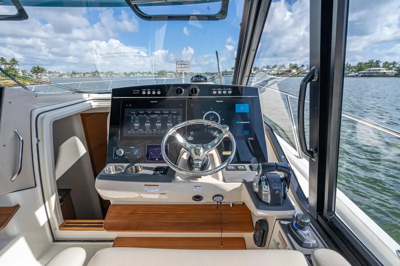 Slide: The Image of 2021 Boston Whaler 405 Conquest helm with advanced navigation system and waterfront view. - 42