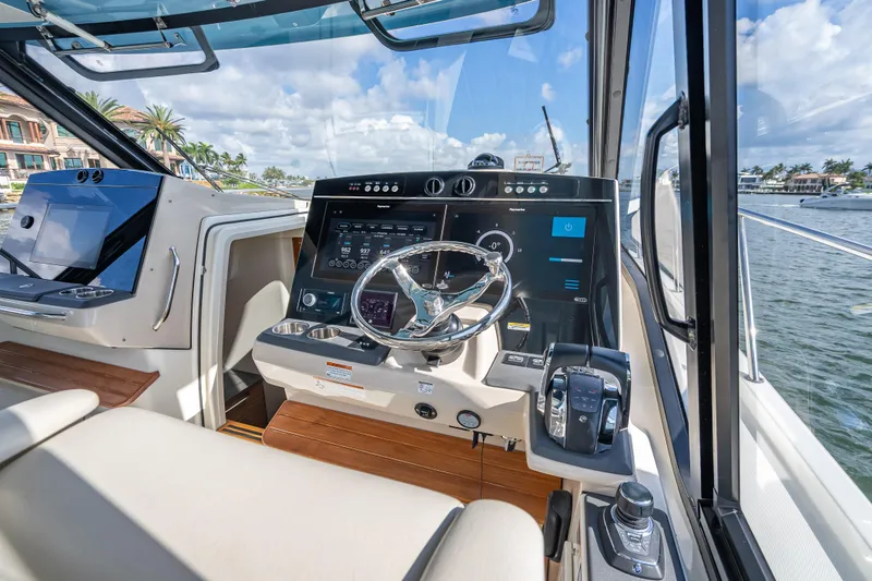 Slide: The Image of Interior helm of 2021 Boston Whaler 405 Conquest with modern navigation controls. - 44