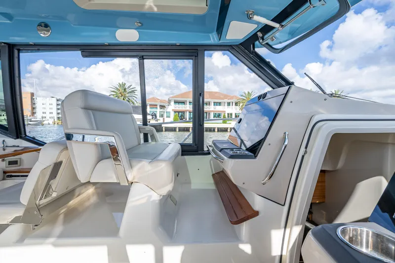 Slide: The Image of Interior of 2021 Boston Whaler 405 Conquest boat with luxurious seating and helm. - 47