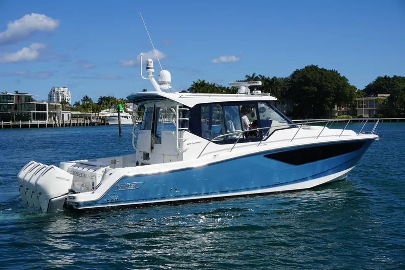 Slide: The Image of 2021 Boston Whaler 405 Conquest boat cruising on a sunny day in a coastal area. - 5