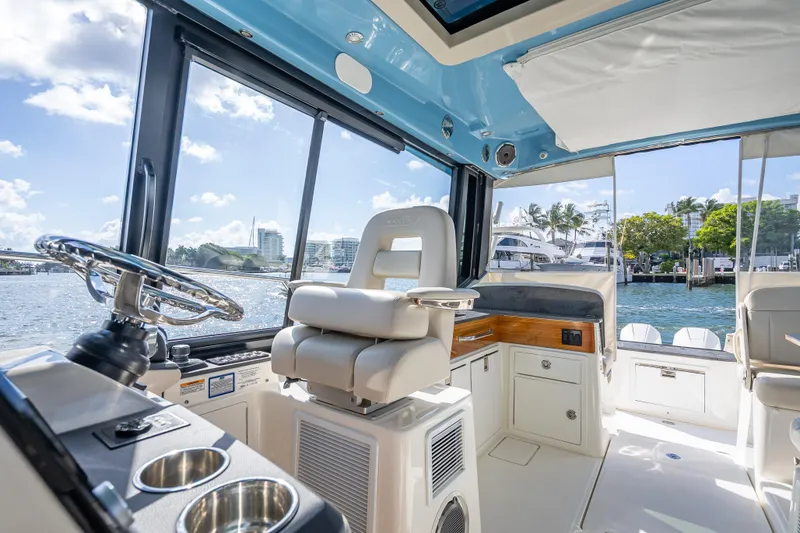 Slide: The Image of Interior of 2021 Boston Whaler 405 Conquest boat with helm and seating area. - 51
