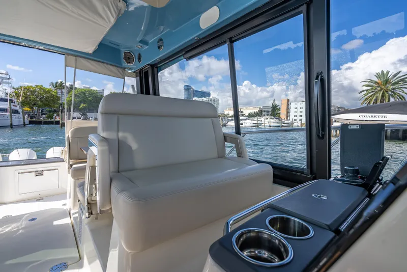 Slide: The Image of Interior view of 2021 Boston Whaler 405 Conquest yacht with luxurious seating and waterfront backdrop. - 52