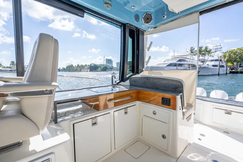 Slide: The Image of Interior view of 2021 Boston Whaler 405 Conquest yacht with waterfront backdrop. - 53