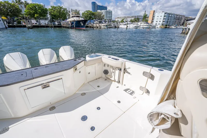 Slide: The Image of Boston Whaler 405 Conquest 2021 boat deck with outboard motors, docked at marina. - 57