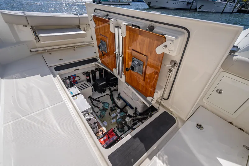 Slide: The Image of Open engine compartment of 2021 Boston Whaler 405 Conquest boat, docked by the water. - 58