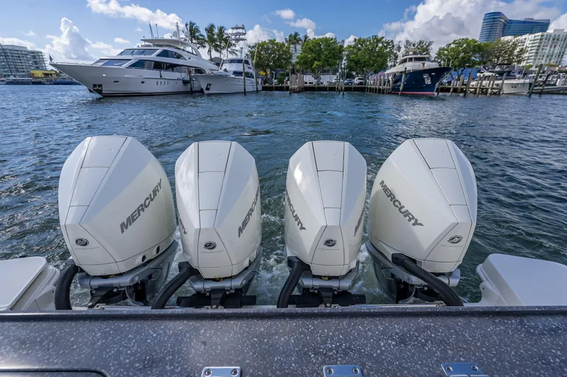 Slide: The Image of Four Mercury outboard engines on a 2021 Boston Whaler 405 Conquest, docked in a marina. - 60