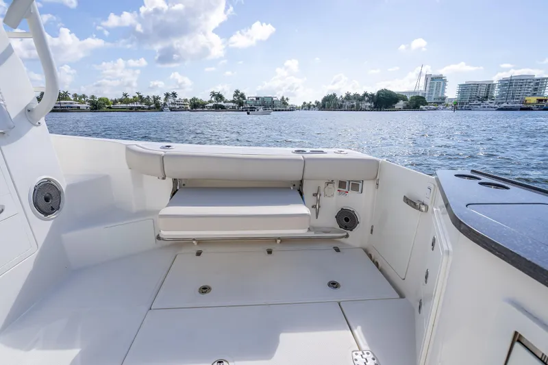 Slide: The Image of 2021 Boston Whaler 405 Conquest boat deck with seating, overlooking water and cityscape. - 61