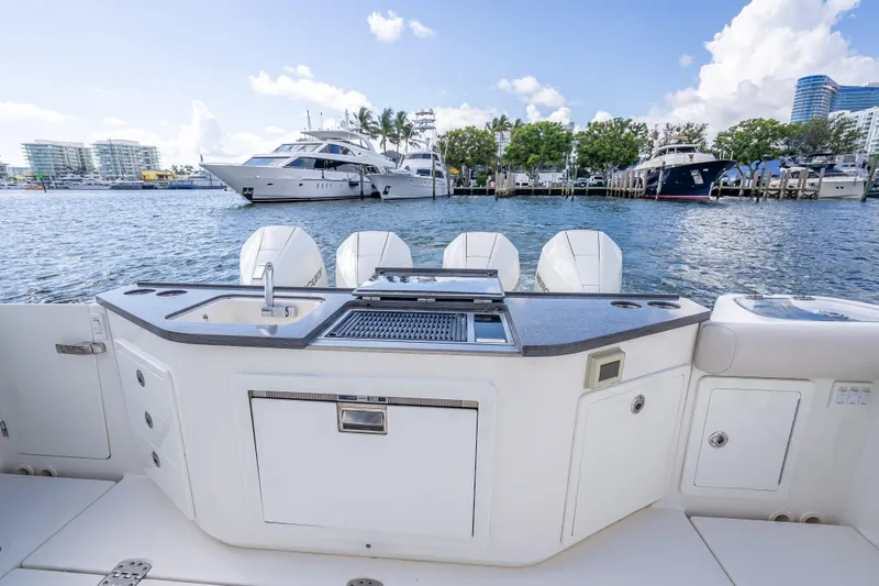 Slide: The Image of Boston Whaler 405 Conquest 2021 boat with outdoor kitchen and scenic marina view. - 64