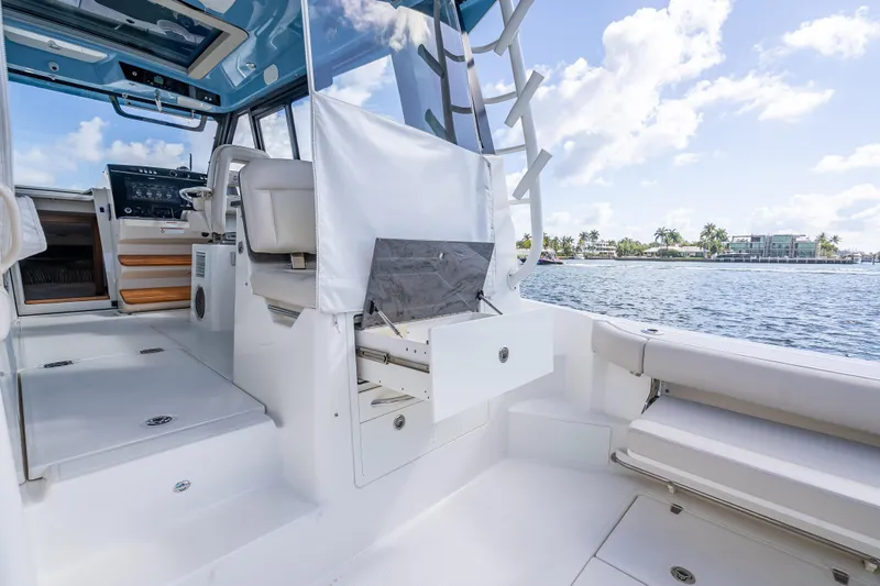 Slide: The Image of 2021 Boston Whaler 405 Conquest interior with helm, seating, and ocean view. - 66