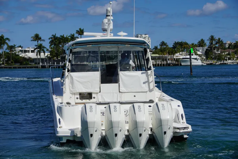 Slide: The Image of 2021 Boston Whaler 405 Conquest boat with four engines on a sunny day. - 9