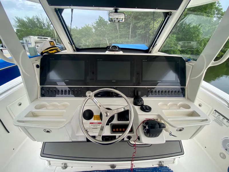 Slide: The Image of 2016 Everglades 435 Center Console helm with advanced navigation displays and controls. - 11