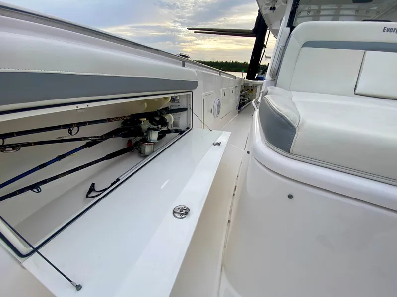 Slide: The Image of 2016 Everglades 435 Center Console boat interior with fishing rod storage. - 15