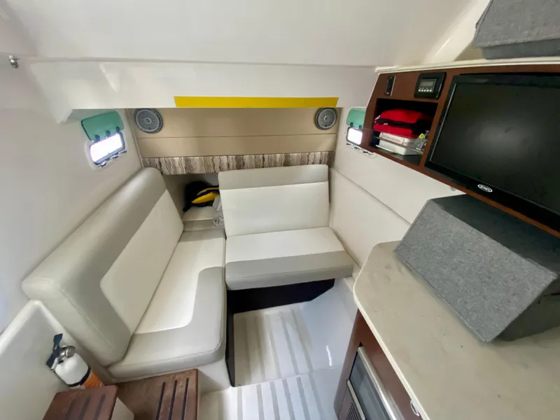 Slide: The Image of Interior of 2016 Everglades 435 Center Console with seating, TV, and storage. - 21