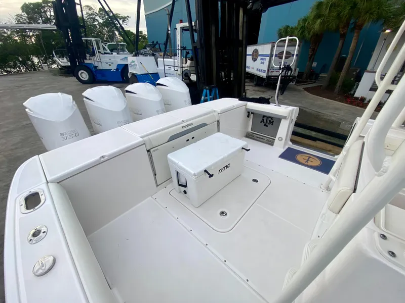Slide: The Image of 2016 Everglades 435 Center Console boat with Yeti cooler and quad engines at dock. - 5