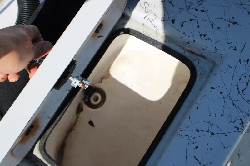 Slide: The Image of Hand opening storage compartment on 2017 Blazer Bay 2170 boat deck. - 11