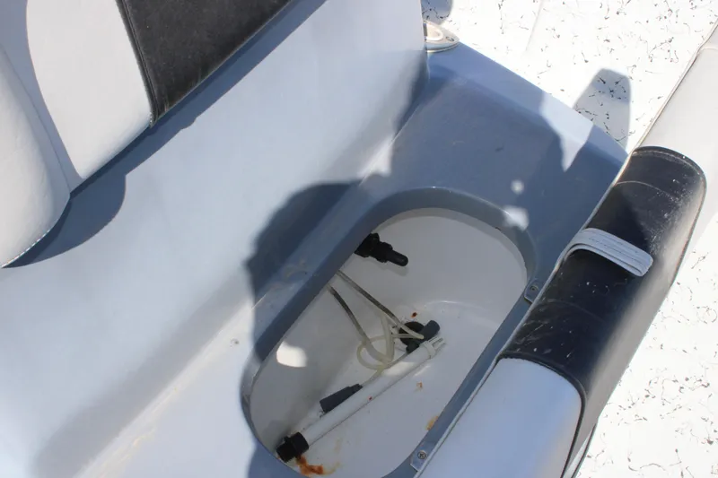 Slide: The Image of 2017 Blazer Bay 2170 boat seat storage compartment with visible hoses and fittings. - 12