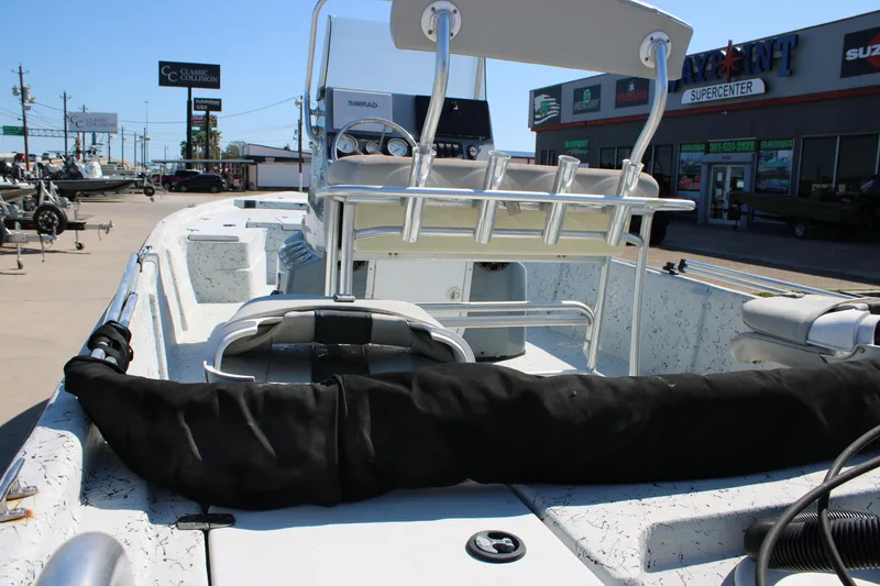 Slide: The Image of 2017 Blazer Bay 2170 boat interior at dealership, featuring seating and control console. - 14