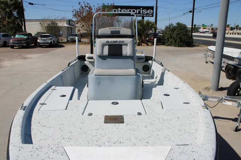 Slide: The Image of 2017 Blazer Bay 2170 boat displayed outdoors, featuring a spacious deck and center console. - 4