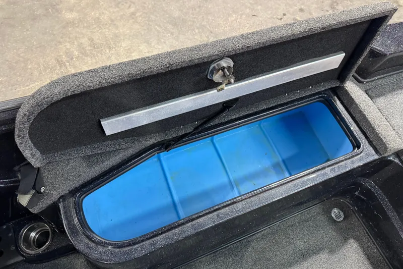 Slide: The Image of Open storage compartment in 2020 Nitro ZV21 boat, featuring a blue interior. - 10