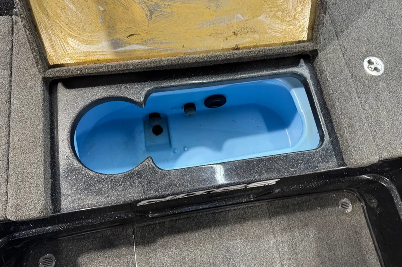Slide: The Image of Open storage compartment in 2020 Nitro ZV21 boat, featuring a blue interior. - 11
