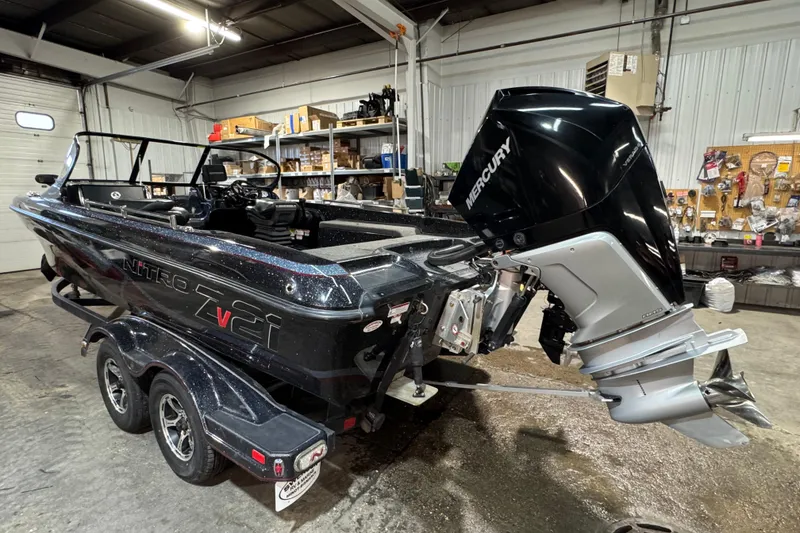 Slide: The Image of 2020 Nitro ZV21 boat with Mercury outboard motor in a garage setting. - 4