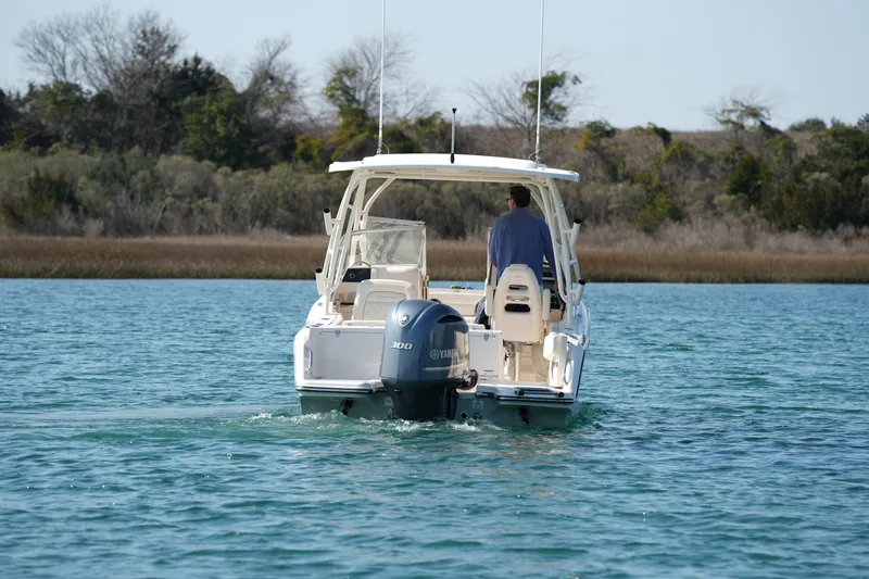 Slide: The Image of 2020 Grady-White Freedom 235 boat cruising on a serene lake. - 10