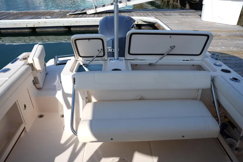 Slide: The Image of 2020 Grady-White Freedom 235 boat interior with open storage compartments at dock. - 16